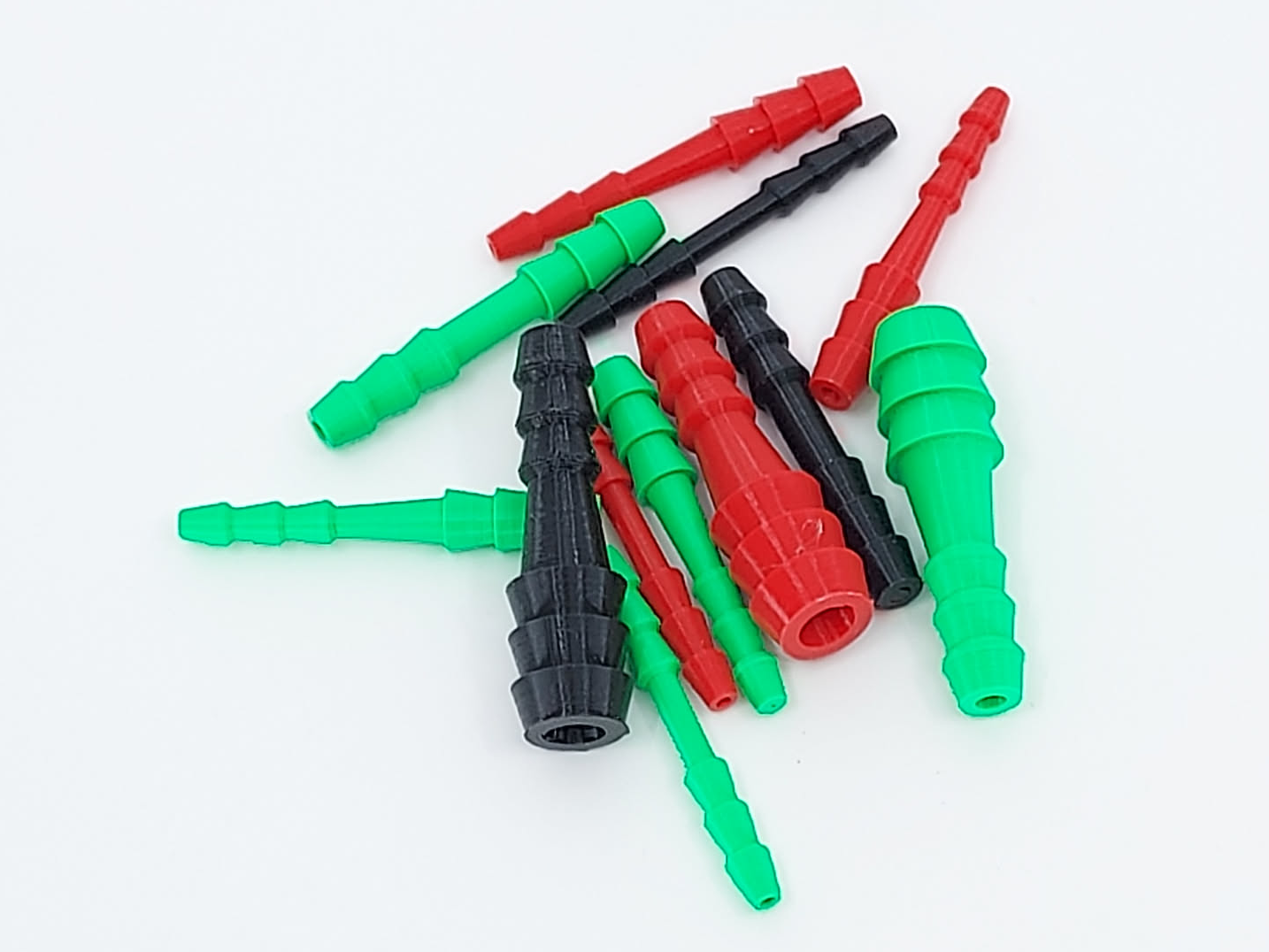 3D-gedruckte Schlauchverbinder und Reduzier-Adapter in Rot, Grün und Schwarz